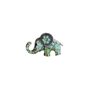Sparkling elephant brooch in alloy with green and blue rhinestones on a white background