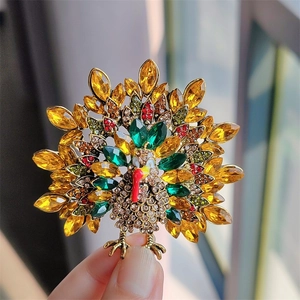 Macro shot of festive turkey brooch with colorful rhinestones on vintage gold metal base