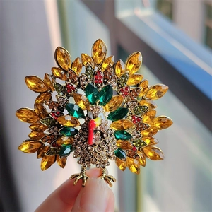 Macro shot of hand-held vintage turkey brooch featuring colorful rhinestones for Thanksgiving