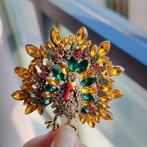 Macro detail of vintage turkey brooch with colorful rhinestones and gold alloy finish