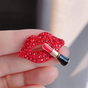Macro shot of creative red lip brooch with crystal rhinestones and lipstick detail