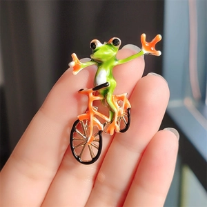 Funny green frog riding a bicycle enamel brooch pin for women jackets and accessories