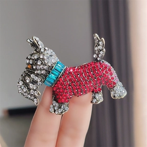 Vintage crystal dog brooch featuring a Scottish Terrier design with red and white rhinestones