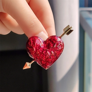Cupid's arrow and red enamel heart brooch in golden metal finish for fashion
