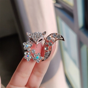 Close-up of elegant fox brooch with sparkling rhinestones and rose gold plating finish