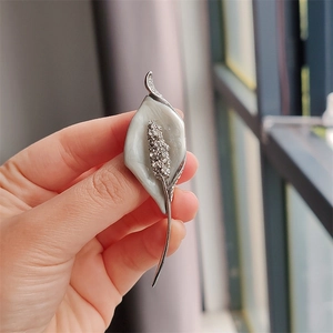 Elegant silver calla lily brooch with white enamel and sparkling rhinestones for women