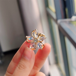 Macro shot of an elegant five-petal flower brooch featuring marquise-cut zircon stones