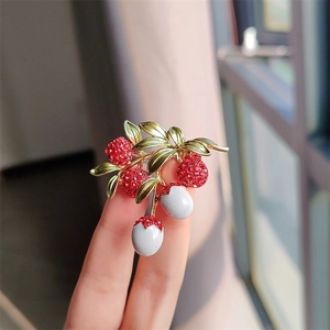 Exquisite red lychee fruit brooch with sparkling rhinestones and green enamel leaf detail