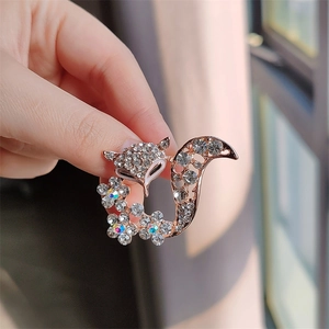 Detailed view of fox brooch with rose gold finish and sparkling crystal inlays