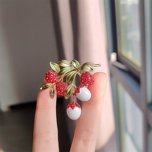 Sweet lychee fruit brooch featuring red crystals and green enamel leaf detail
