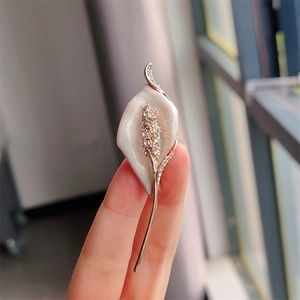Elegant calla lily brooch with white enamel petals and sparkling crystal rhinestones