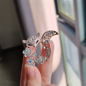 Detailed close-up of a fox brooch with rose gold finish and sparkling rhinestones