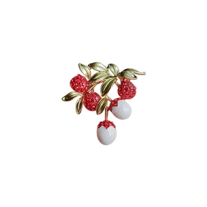 Elegant red lychee fruit brooch with sparkling crystals and gold leaf details
