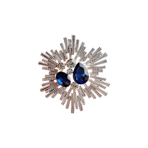 Elegant silver sunburst brooch with navy blue pear-cut crystals and sparkling rhinestones