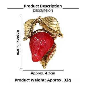 Detailed view of resin strawberry brooch with dimensions 6.3cm height and 4.5cm width