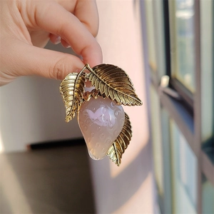 Sweet pink resin strawberry brooch with gold leaf accents for elegant coat accessory