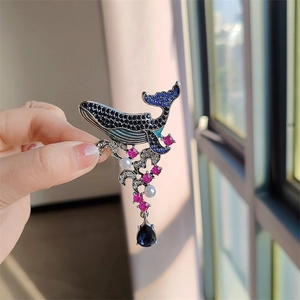 Vintage whale brooch with blue rhinestones, enamel finish, pearls, and tassel pendant