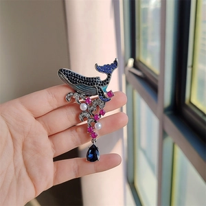 Vintage enamel whale brooch with sparkling rhinestones and blue teardrop pendant charm