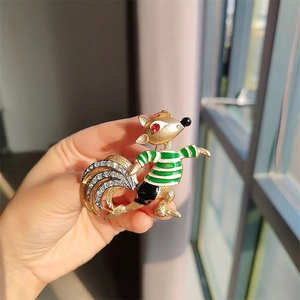 Close-up of vintage fox brooch with enamel stripes and crystal-embellished tail detail
