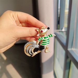 Detailed macro view of squirrel brooch with green enamel and white zircon inlay