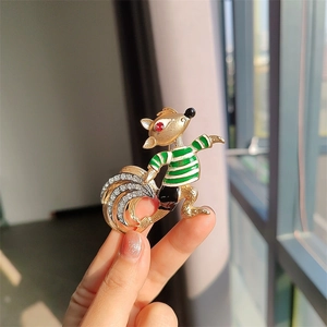 Vintage style fox brooch with green stripes and rhinestones held in hand for sizing