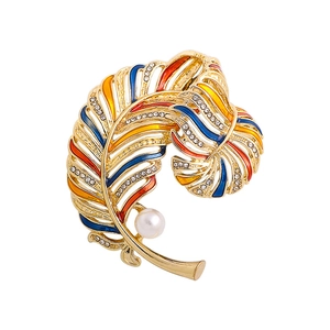 Luxurious gold feather brooch with colorful enamel, sparkling crystals and white pearl
