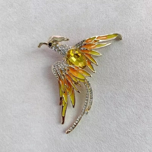 Détails de la broche phénix en cristal avec émail jaune et strass brillants scintillants