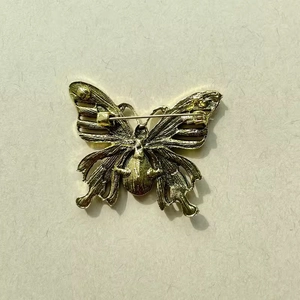 Golden butterfly brooch with detailed hollow texture and secure safety pin fastener back