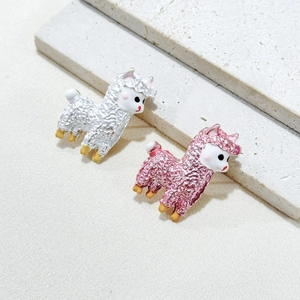 Set of two sweet alpaca brooches in silver and pink enamel finish on a textured background