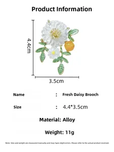 Detail view showing dimensions of white daisy brooch with green enamel leaves and yellow core