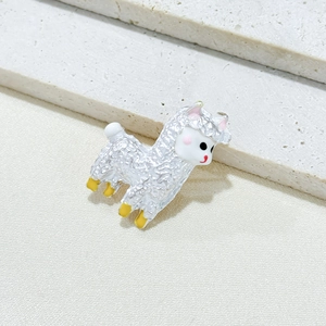 Cute alpaca brooch pin in silver finish with colorful enamel details on textured background