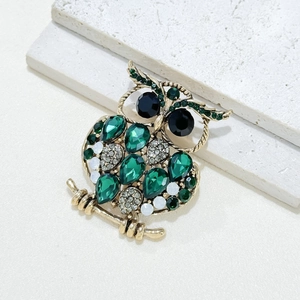 Vintage gold owl brooch with emerald green water drop crystals and white diamond accents