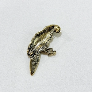 Detailed back view of vintage eagle brooch showing safety pin clasp and metal texture