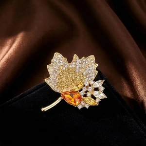 Exquisite maple leaf brooch with amber crystal and rhinestones on black velvet