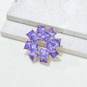 Elegant silver ring brooch featuring square purple crystals in a wreath-like circular design