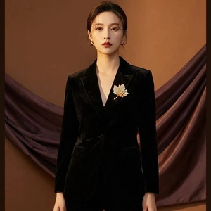 Luxurious maple leaf brooch with orange gradient rhinestones on a black velvet blazer