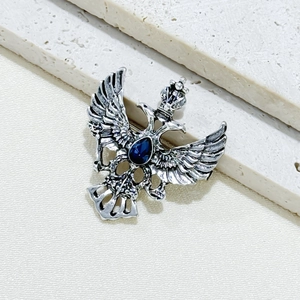 Silver double-headed eagle brooch with crown and blue teardrop rhinestone inlay
