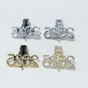 Detailed back view of four-color 2025 snake brooches showing sturdy metal pin fasteners
