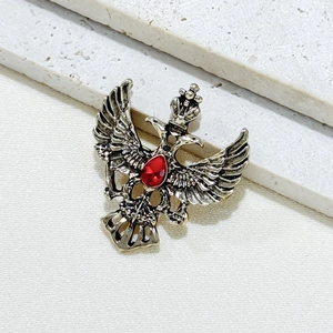Vintage double-headed eagle brooch with red teardrop rhinestone and silver finish