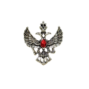 Vintage silver double-headed eagle brooch with central red teardrop rhinestone