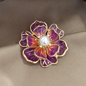 Elegant purple enamel peony brooch with pearl center and crystals on silk background