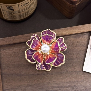 Detailed view of vintage peony brooch with purple orange gradient petals and a center pearl