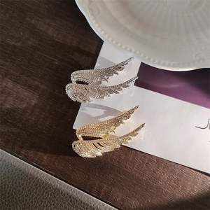 Exquisite angel wing brooches in gold and silver finish with sparkling crystal embellishments