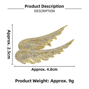 Detailed view of gold angel wing brooch with white rhinestones measuring 2.5cm in height
