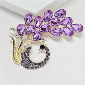 Elegant purple crystal peacock brooch with gold-tone plating and sparkling rhinestones