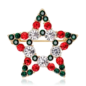 Christmas star brooch with red green and white crystals on a gold plated metal base