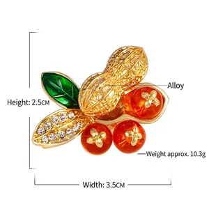 Artistic peanut and berry brooch in gold alloy with green leaves and orange beads