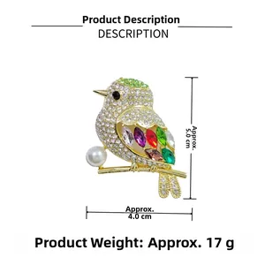 Detail of magpie brooch with colorful gems, crystals and a pearl on golden branch
