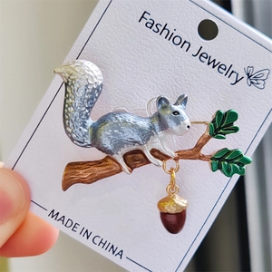 Cute enamel squirrel brooch on branch with acorn pendant and green leaves