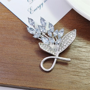 Elegant silver leaf brooch with emerald cut blue crystals and micro-pave rhinestones